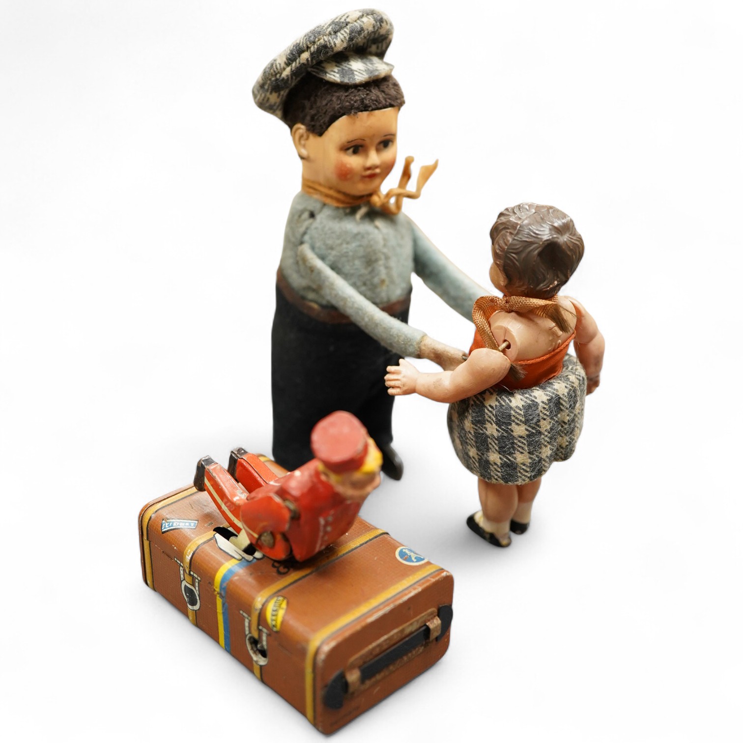 A Gescha, DRGM (Germany), clockwork tinplate acrobatic bellboy on ‘Express’ trunk, together with a Schuco, Germany tinplate and cellulose clockwork man with girl automaton